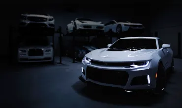 Cars lined up in an automotive dealership showroom